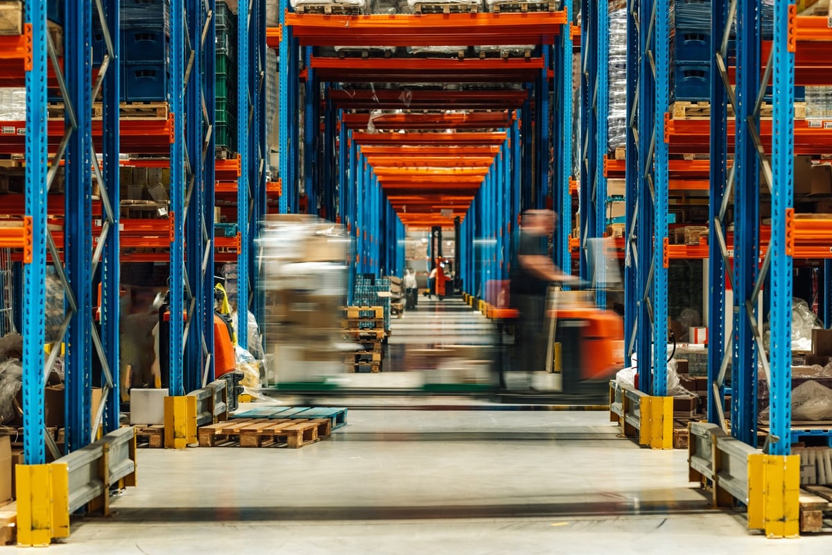 Warehouse workers with forklifts
