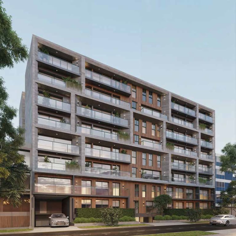 Modern mixed-use apartment building with brick and metal facade, ground floor garage, and terraced upper levels with glass railings