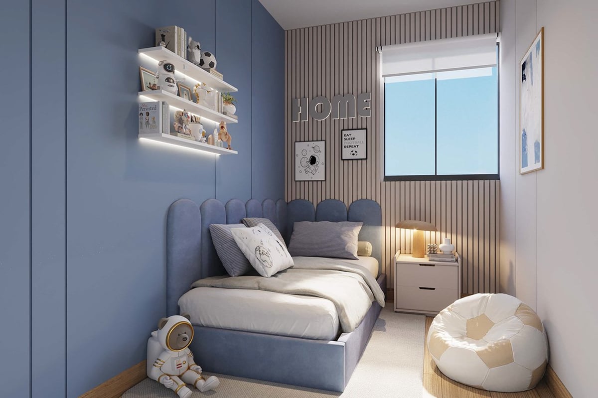 Modern childs bedroom with blue-gray bed, illuminated white shelves, wood accent wall, window, and cream bean bag chair