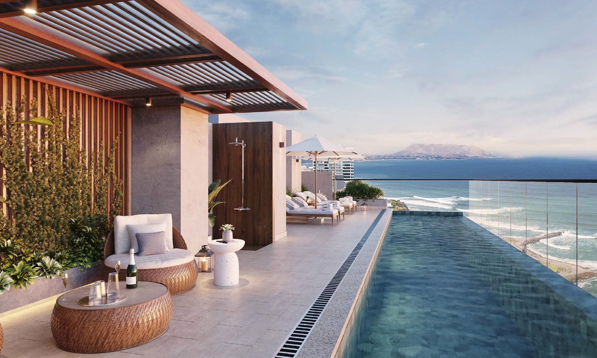 Modern rooftop terrace with infinity pool overlooking the sea and snow-capped mountains in the distance