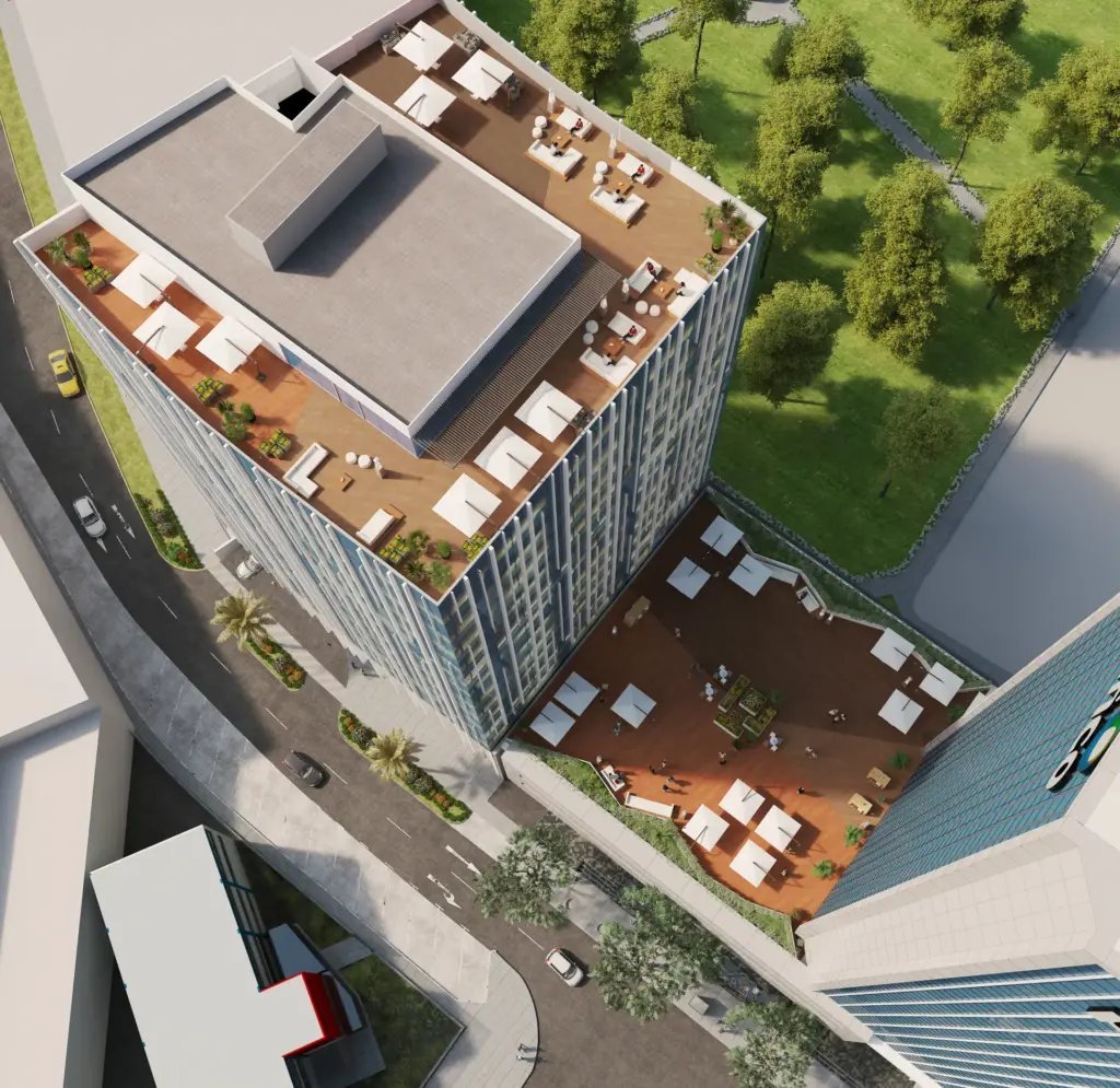 Aerial view of a modern residential building rooftop with lounge areas, seating spaces, green landscaping, and adjacent waterfront
