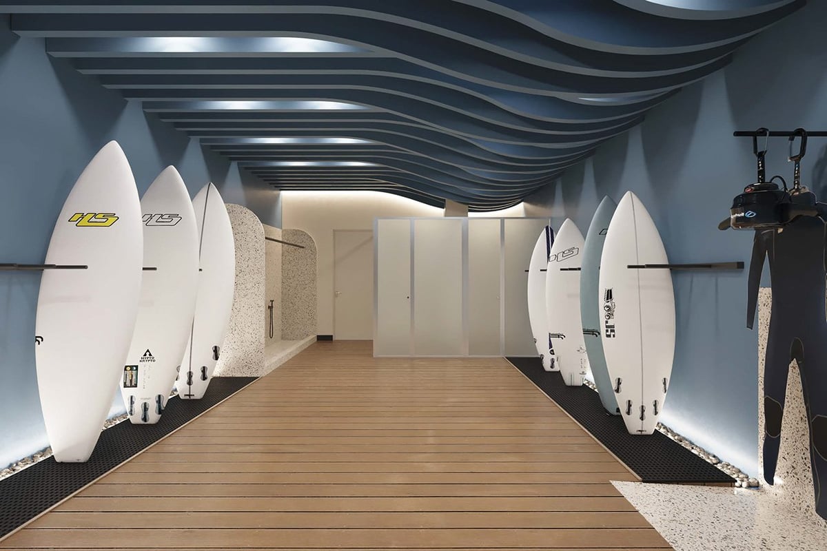 Modern surfboard shop interior with white surfboards displayed on both sides of a wooden walkway and wavy ceiling design