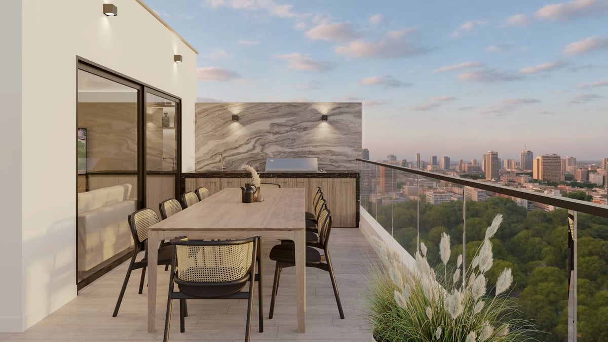 Modern balcony with dining area, chairs, and city skyline view in the distance under partly cloudy sky