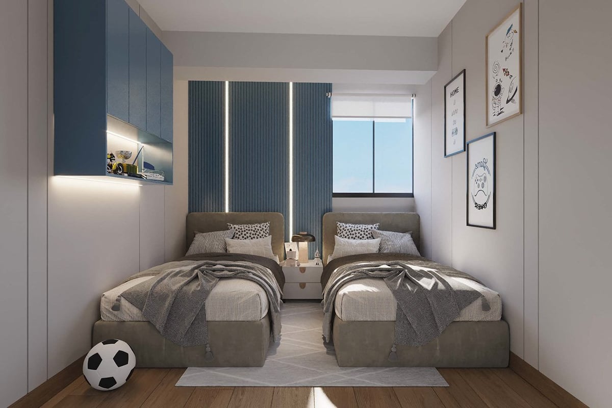 Modern bedroom with two twin beds, dark blue accent wall, and soccer ball decoration on wooden floor