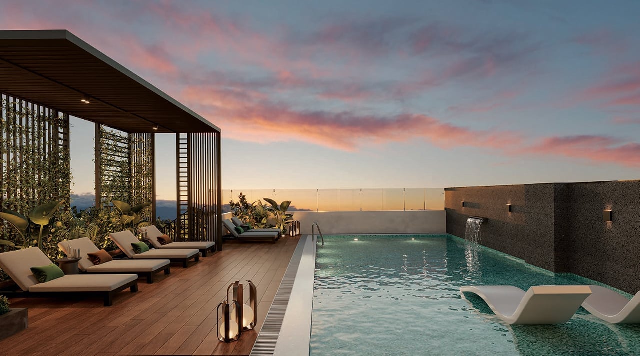 Luxury rooftop pool deck at sunset with lounge chairs, modern pergola, and city views