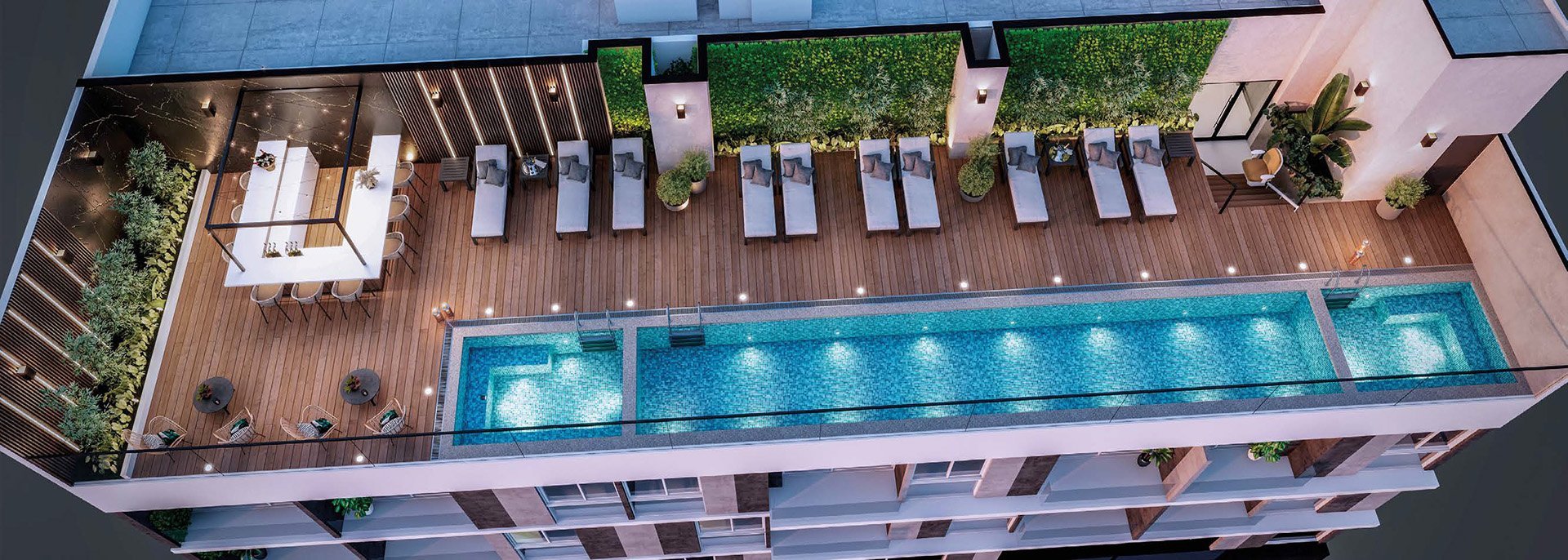 Aerial view of modern rooftop with rectangular pool, wooden deck, lounge chairs, and landscaping