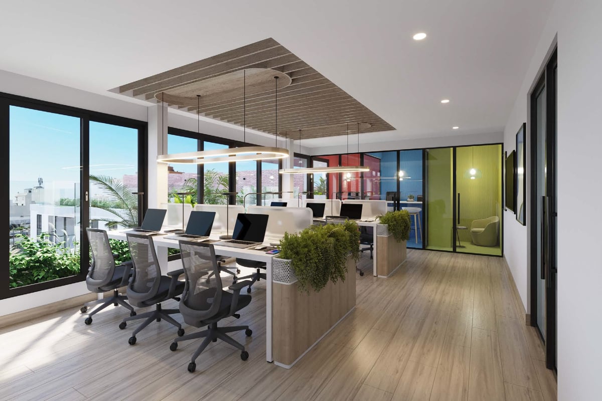Modern open-plan office space with ergonomic desk chairs, wooden flooring, large windows, colorful glass partition walls, and contemporary ceiling design.