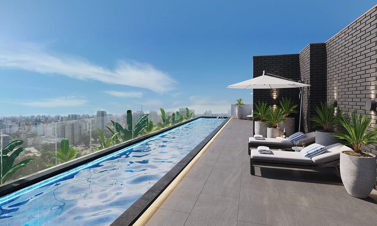 Modern rooftop terrace with infinity pool, lounge chairs, potted plants, and city skyline view under clear blue sky
