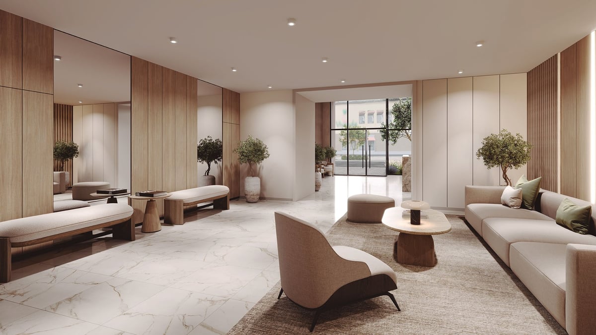 Modern luxury spa reception area with marble flooring, cream and wood interior, curved seating, and natural lighting from large windows
