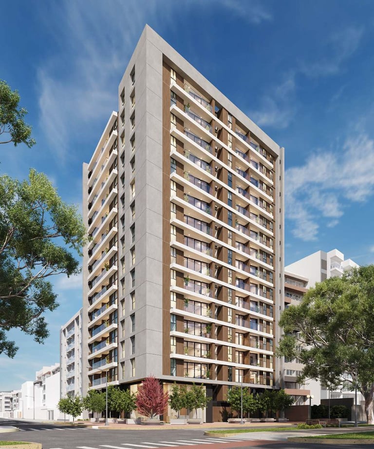 Modern apartment building with multiple residential units, beige concrete facade, and balconies under blue sky with surrounding trees