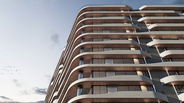 Curved modern residential building with multiple balconies photographed against a cloudy sky
