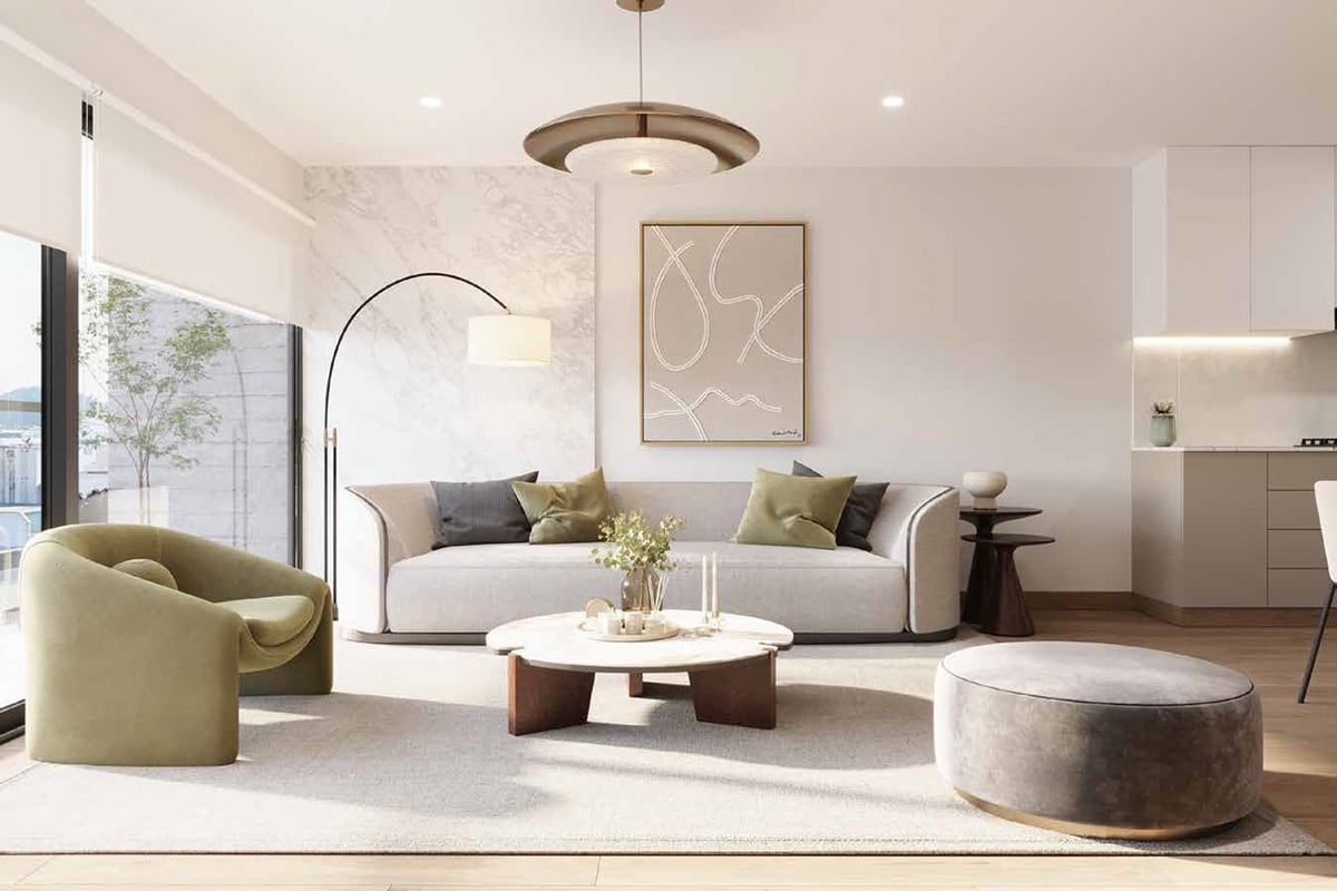 Modern living room with beige sofa, round coffee table, accent chairs, and contemporary ceiling fixture