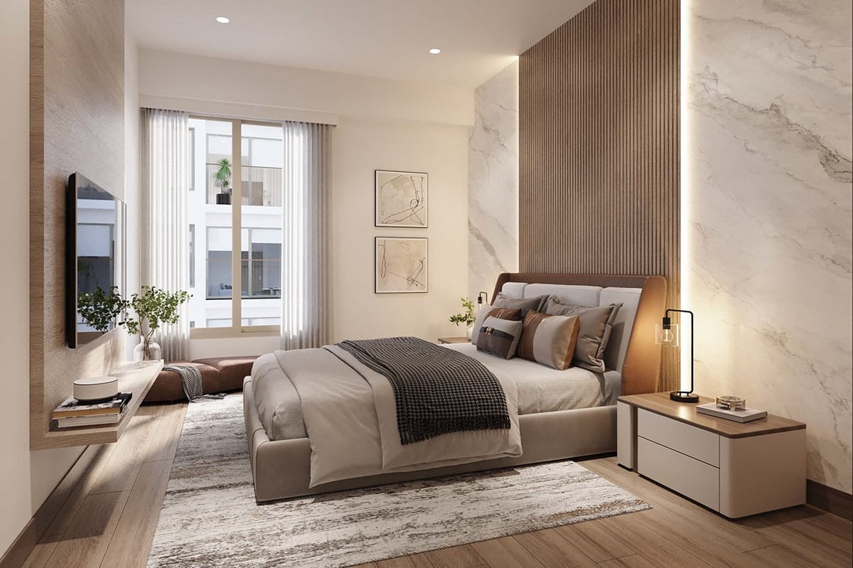 Modern bedroom with beige bed, wooden and marble accents, large window, and contemporary furniture.