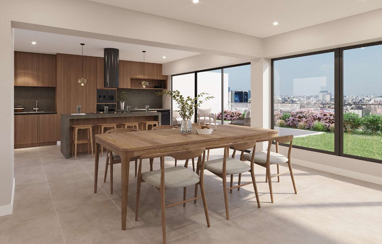 Modern open-plan kitchen and dining room with wooden furniture, large windows overlooking cityscape, and natural lighting