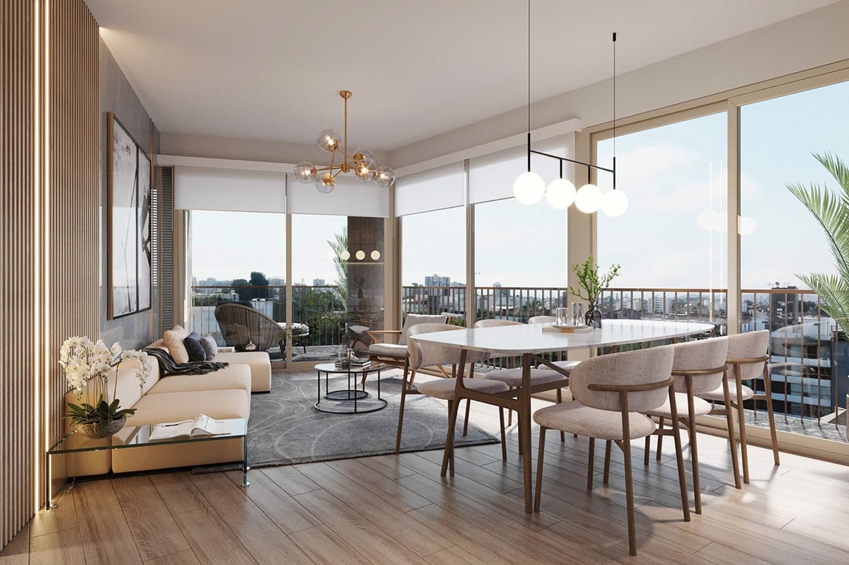 Modern high-rise apartment with open-plan living and dining areas, floor-to-ceiling windows overlooking a cityscape, contemporary furniture, and wooden flooring throughout