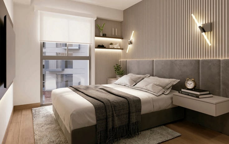 Modern bedroom with gray upholstered bed, wall-mounted shelving, wood flooring, and natural light from glass door
