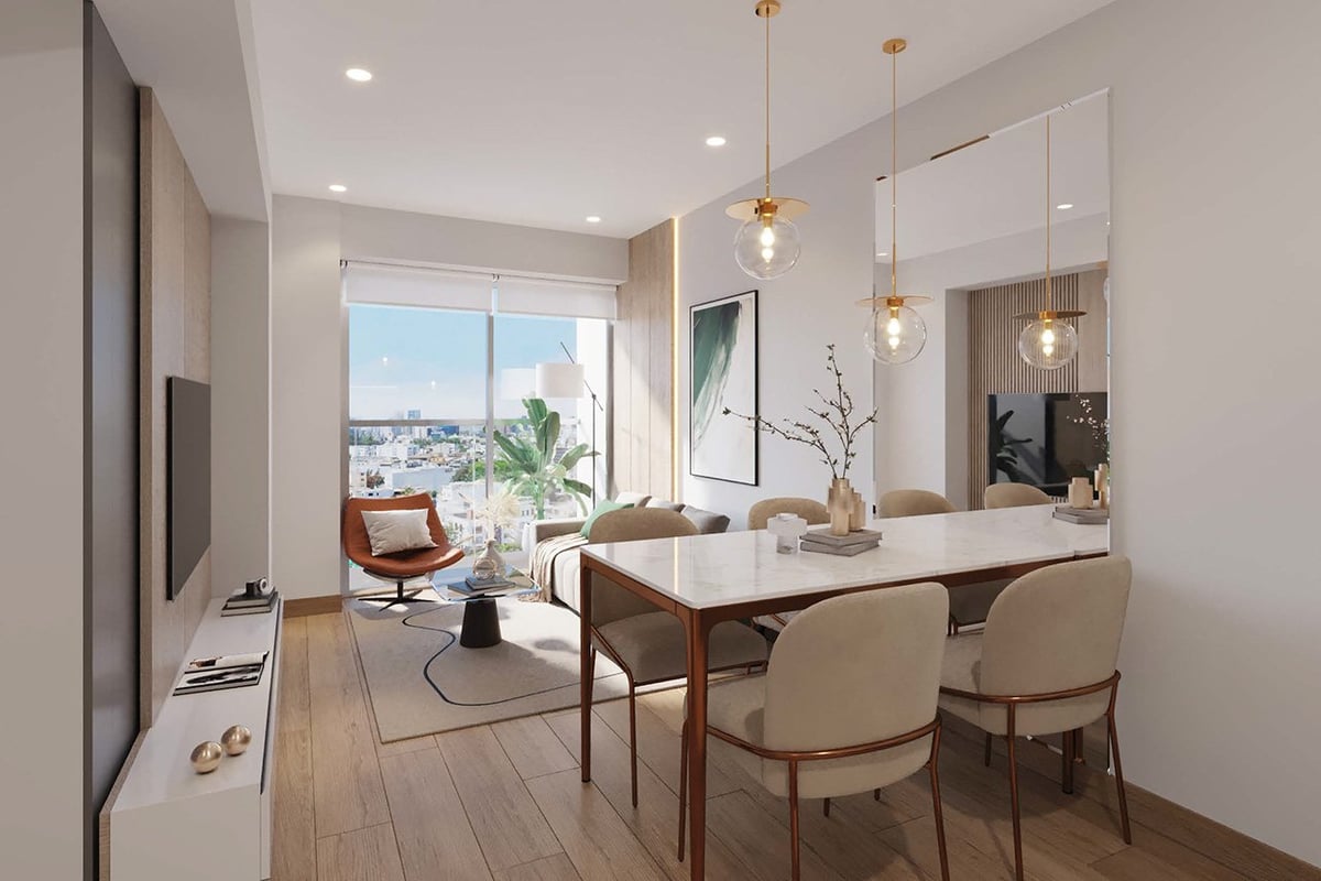 Modern apartment interior with dining table, pendant lights, and waterfront view through large windows
