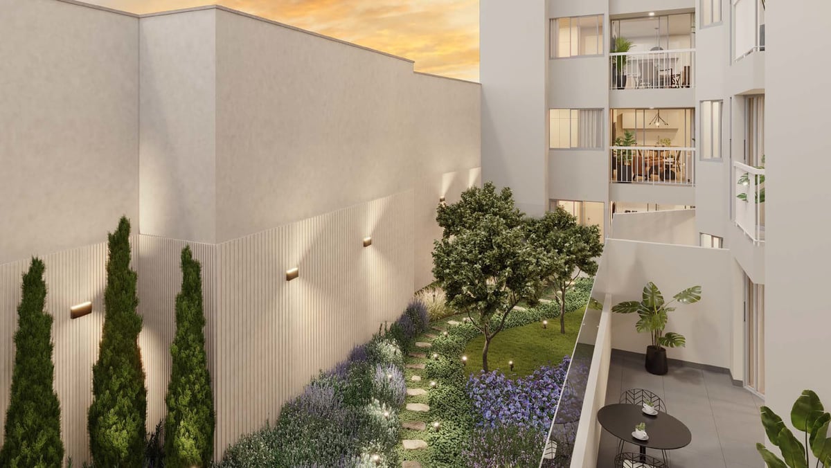 Aerial view of a modern courtyard garden with lighting, green plants, trees, and adjacent residential building at dusk