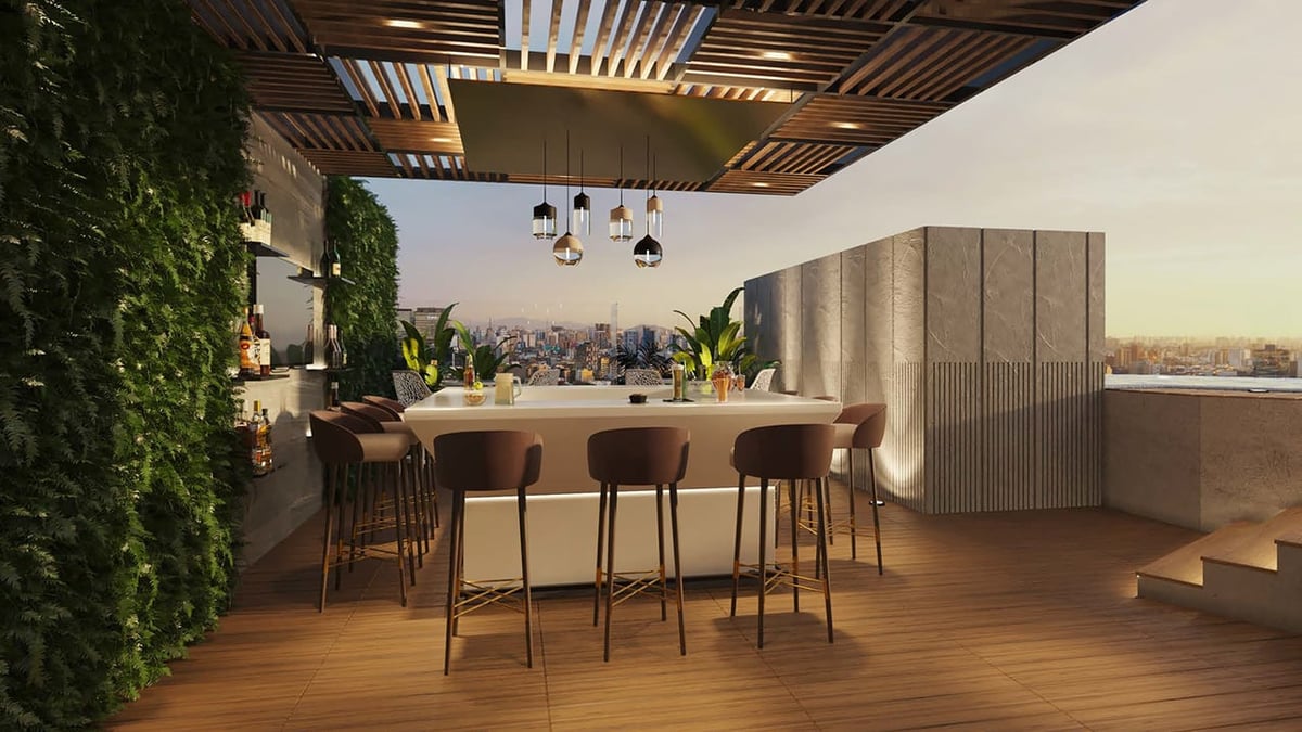 Modern rooftop bar with high seating, wooden ceiling, hanging lights, lush greenery, and city skyline view through large windows