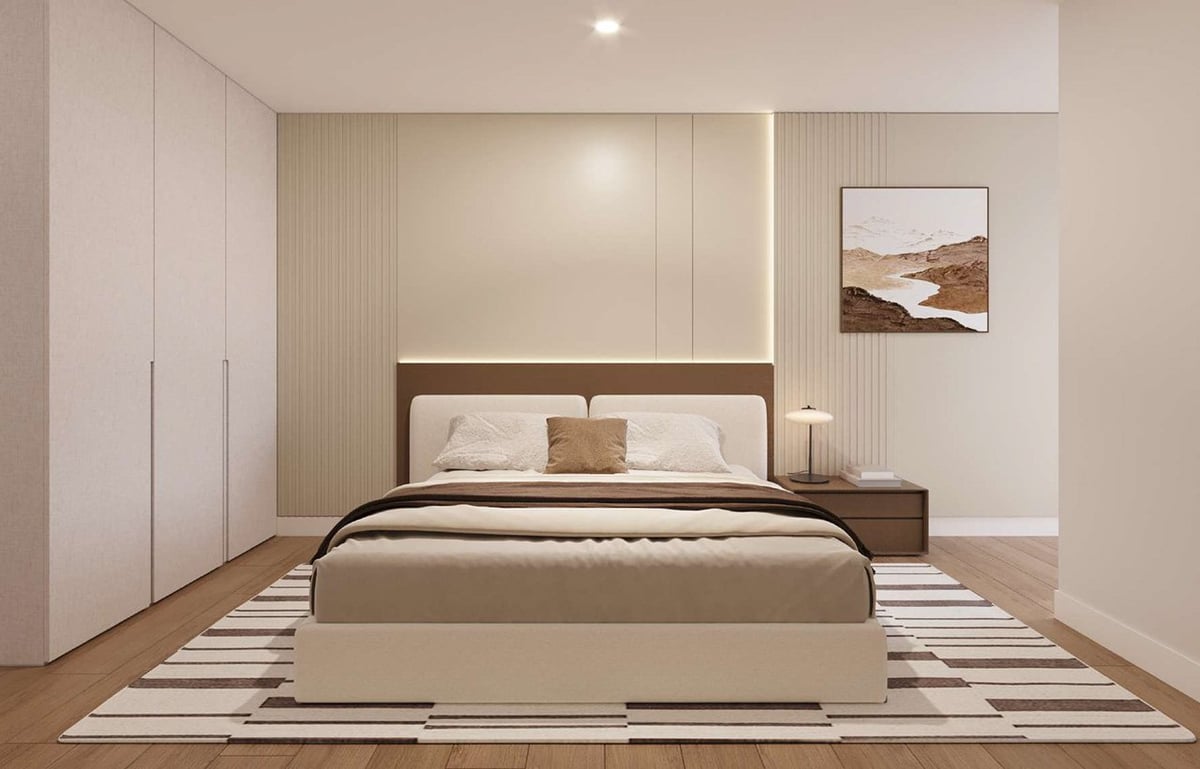 Modern bedroom with brown platform bed, white pillows, striped area rug, white built-in wardrobes, and minimalist decor