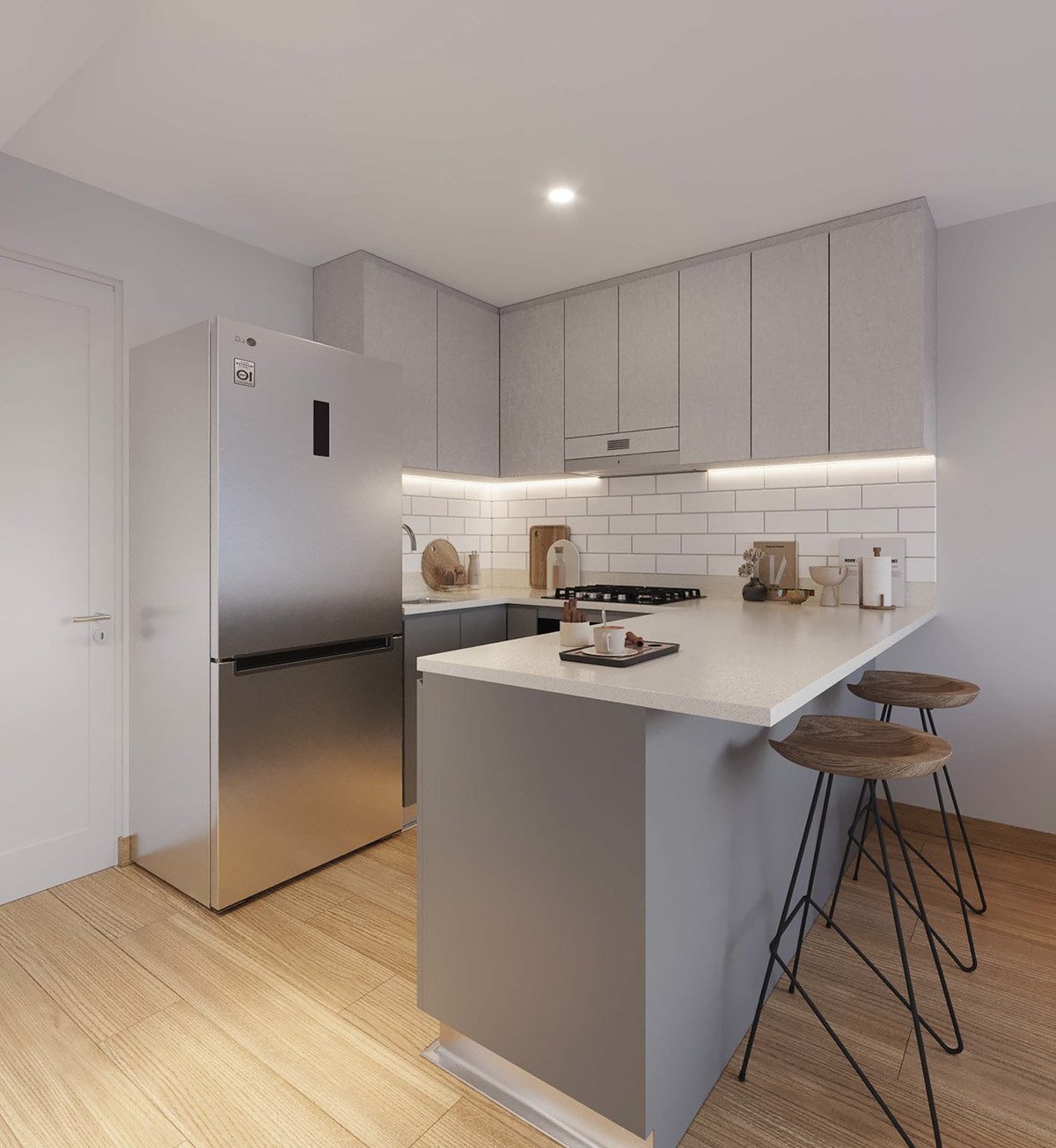Modern minimalist kitchen with gray cabinetry, white subway tile backsplash, stainless steel refrigerator, island with bar seating, and wooden flooring