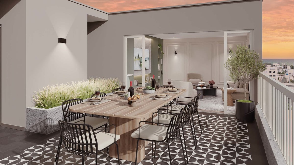 Modern rooftop terrace with wooden dining table, black chairs, decorative plants, and city views at sunset