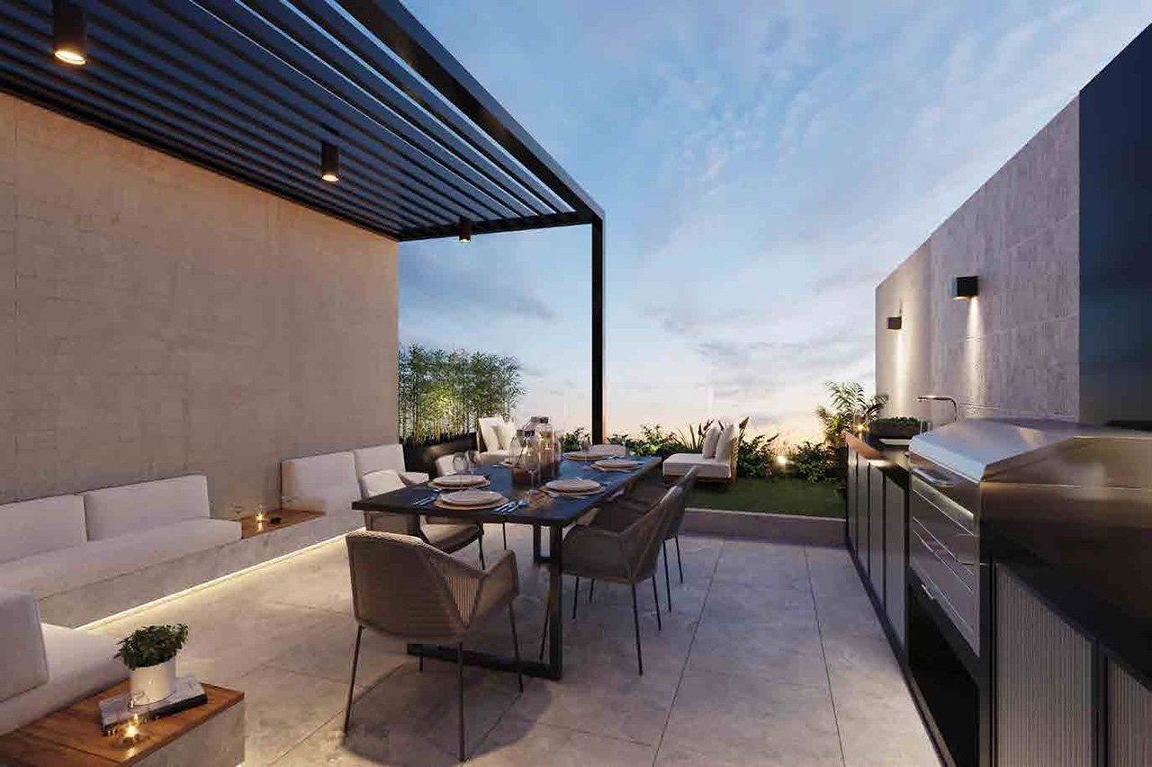 Modern rooftop terrace with dining table, chairs, pergola, outdoor kitchen, and city views at dusk