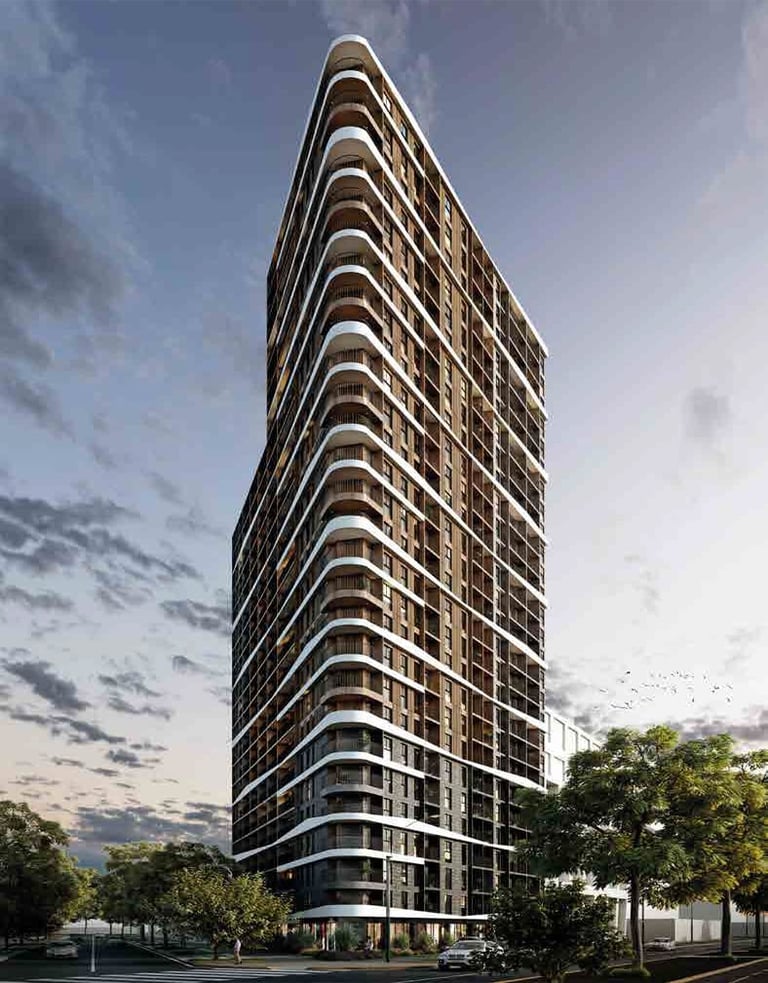 Modern high-rise residential apartment tower with curved balconies and glass facade against cloudy sky