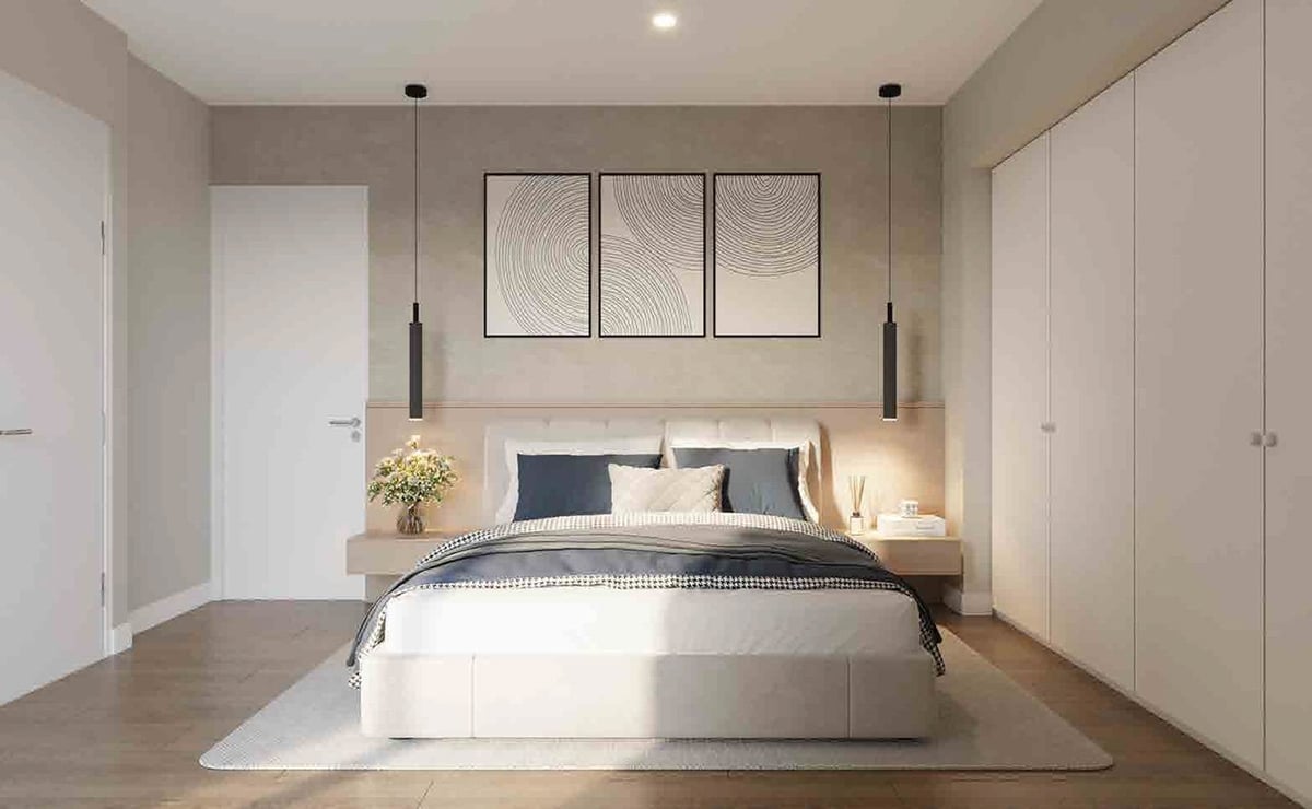 Modern minimalist bedroom with neutral tones, white bed with black pillows, wall-mounted artwork, pendant lights, and built-in wardrobes