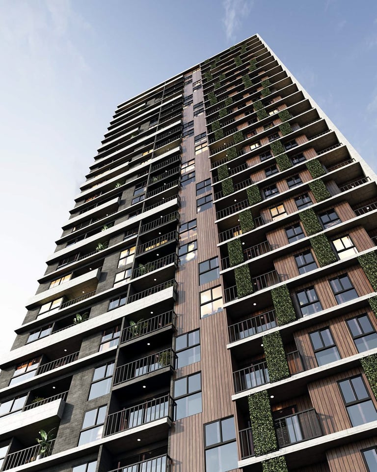 Tall modern residential high-rise building with multiple balconies, mixed materials, and climbing green vegetation against a blue sky