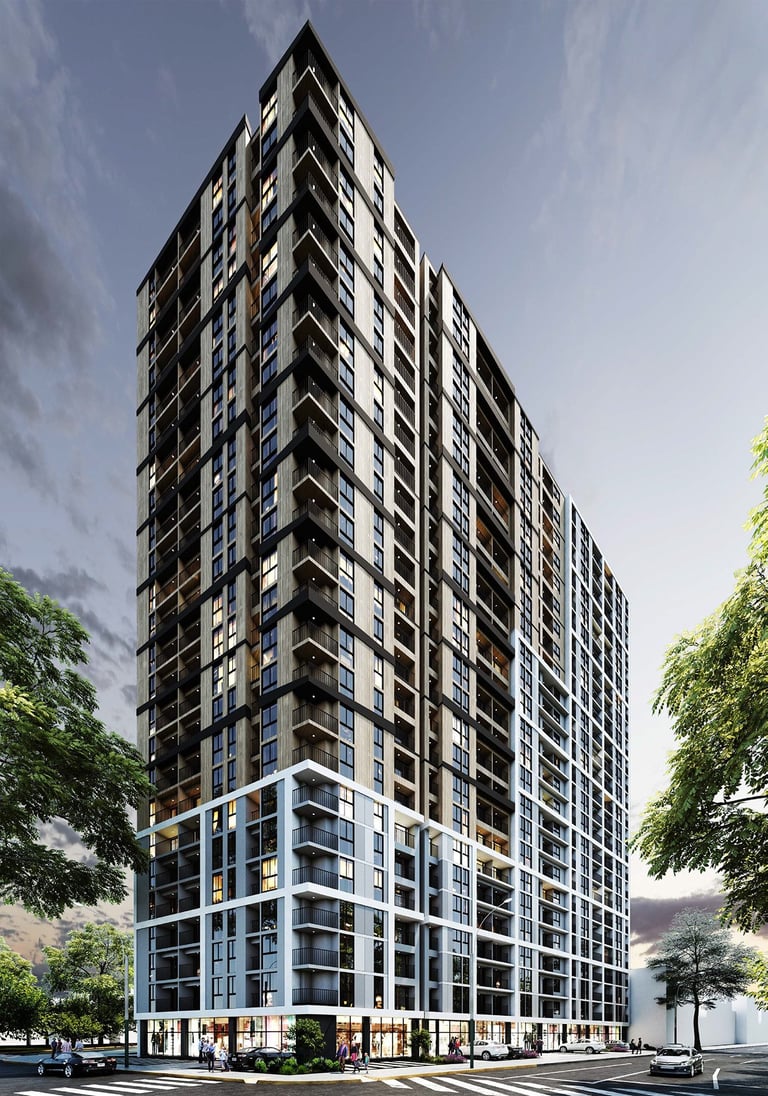 Modern high-rise residential tower with dark upper floors and blue-toned base, featuring multiple balconies against a cloudy sky with surrounding trees