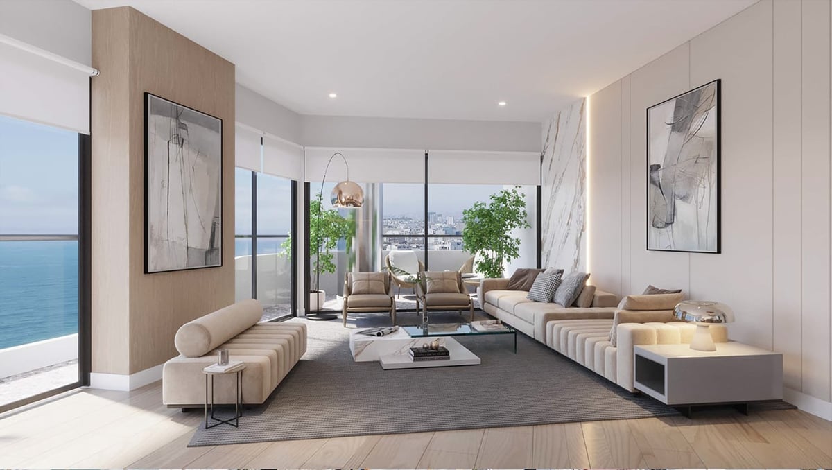 Modern high-rise living room with floor-to-ceiling windows overlooking the ocean, contemporary beige furniture, and minimalist decor.