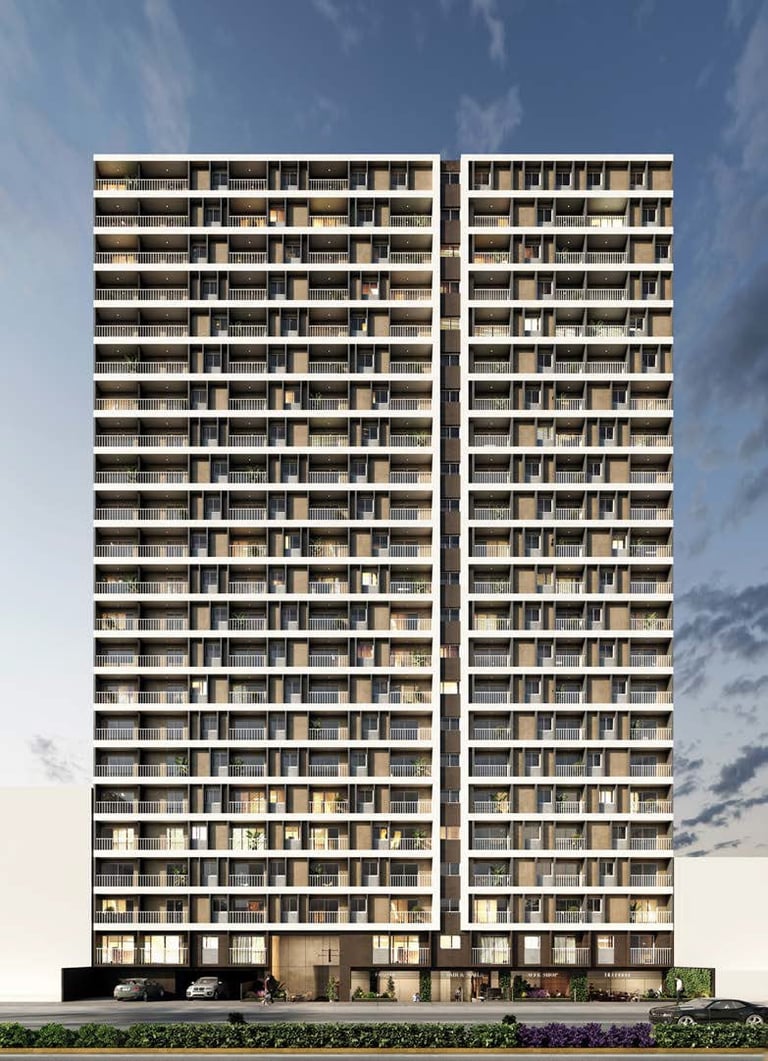 Modern residential high-rise apartment building with two connected towers, balconies, and ground-level retail spaces against a blue sky