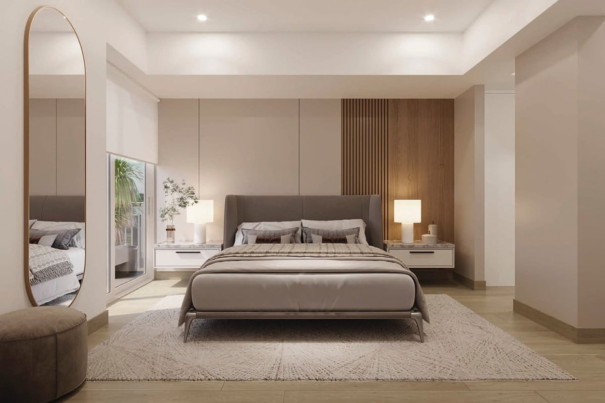 Modern bedroom with gray upholstered bed, mirrored wardrobe, neutral color scheme, and recessed ceiling lighting