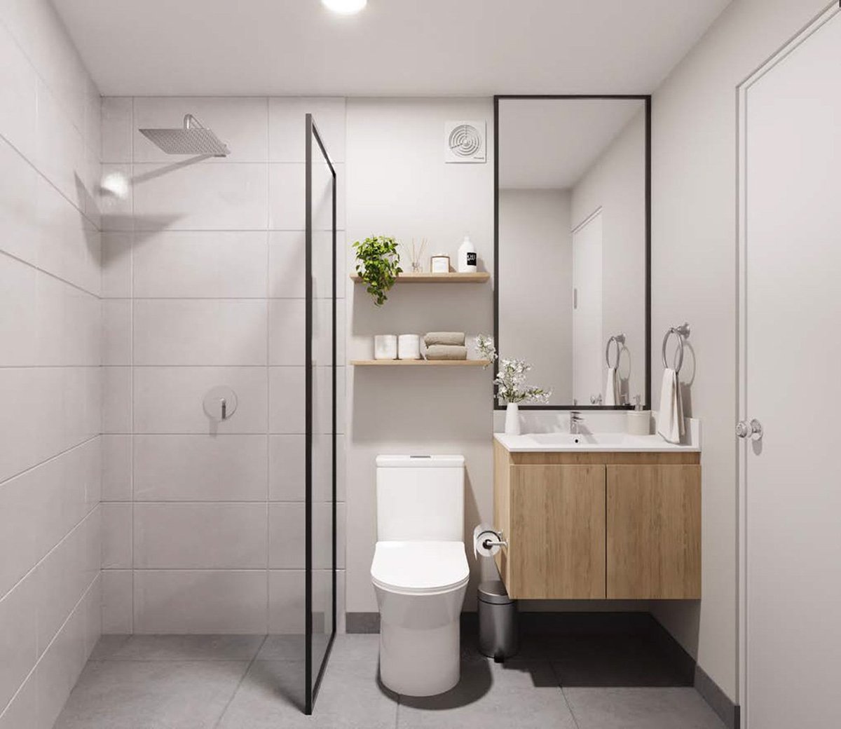 Modern bathroom with white tile walls, walk-in shower, wooden vanity, toilet, and floating shelves with decor