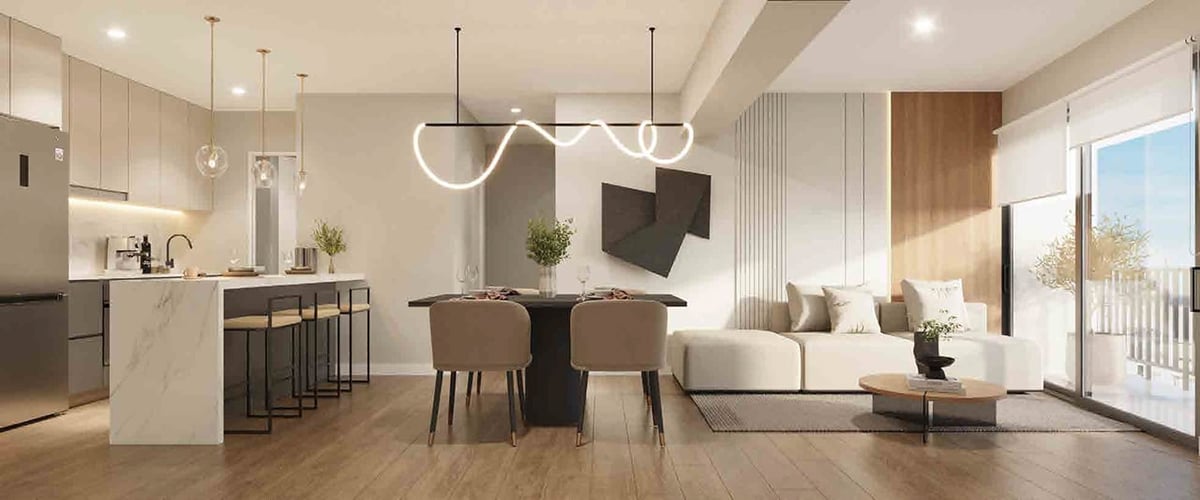 Modern open-concept apartment with dining table, kitchen, living room, and pendant lighting throughout the space
