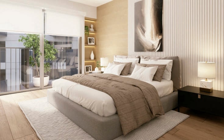 Modern bedroom with beige platform bed, brown bedding, built-in shelving, glass doors overlooking a patio, and contemporary artwork