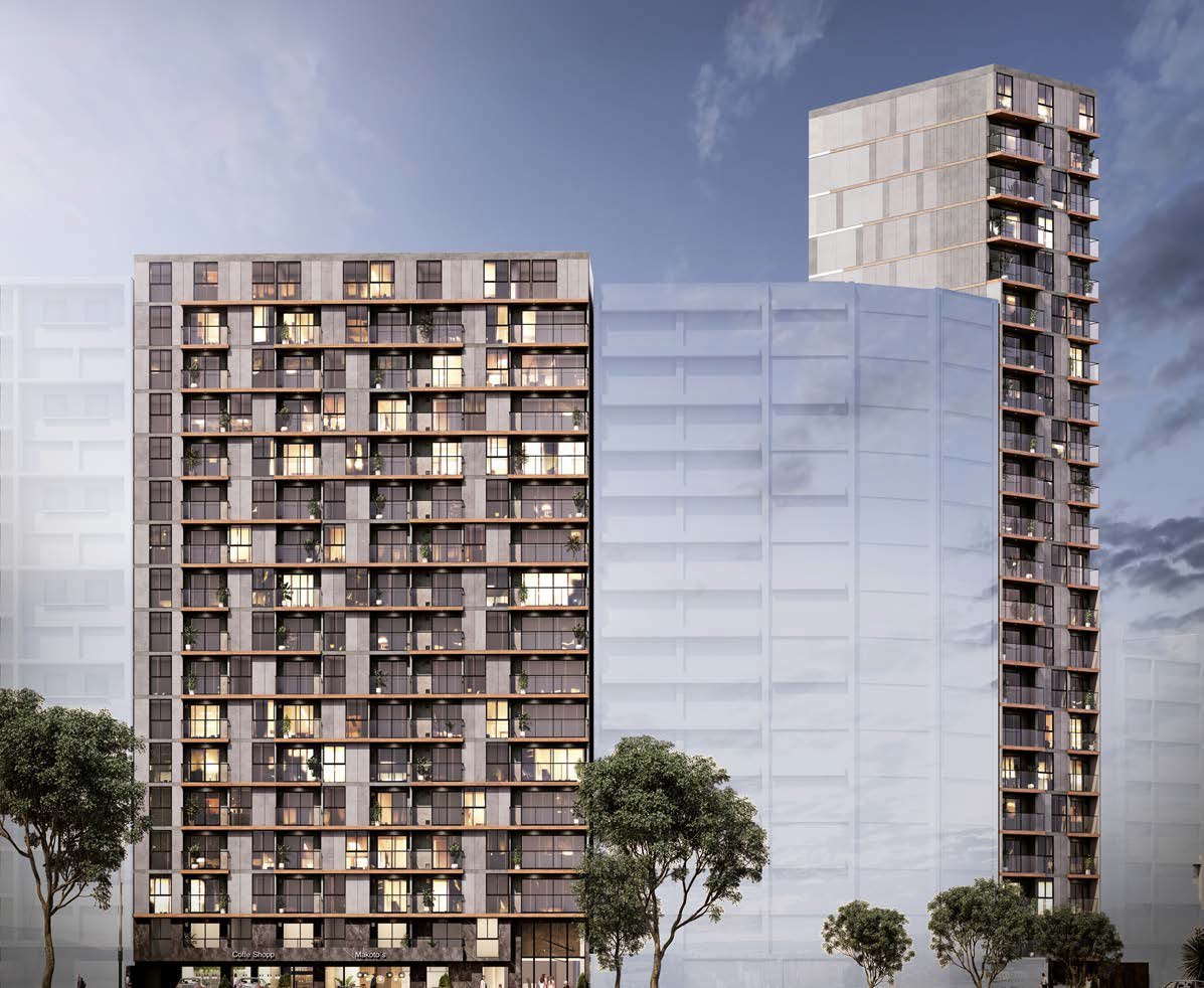 Modern residential buildings with one dark textured facade and illuminated windows beside a tall glass-clad tower against cloudy sky
